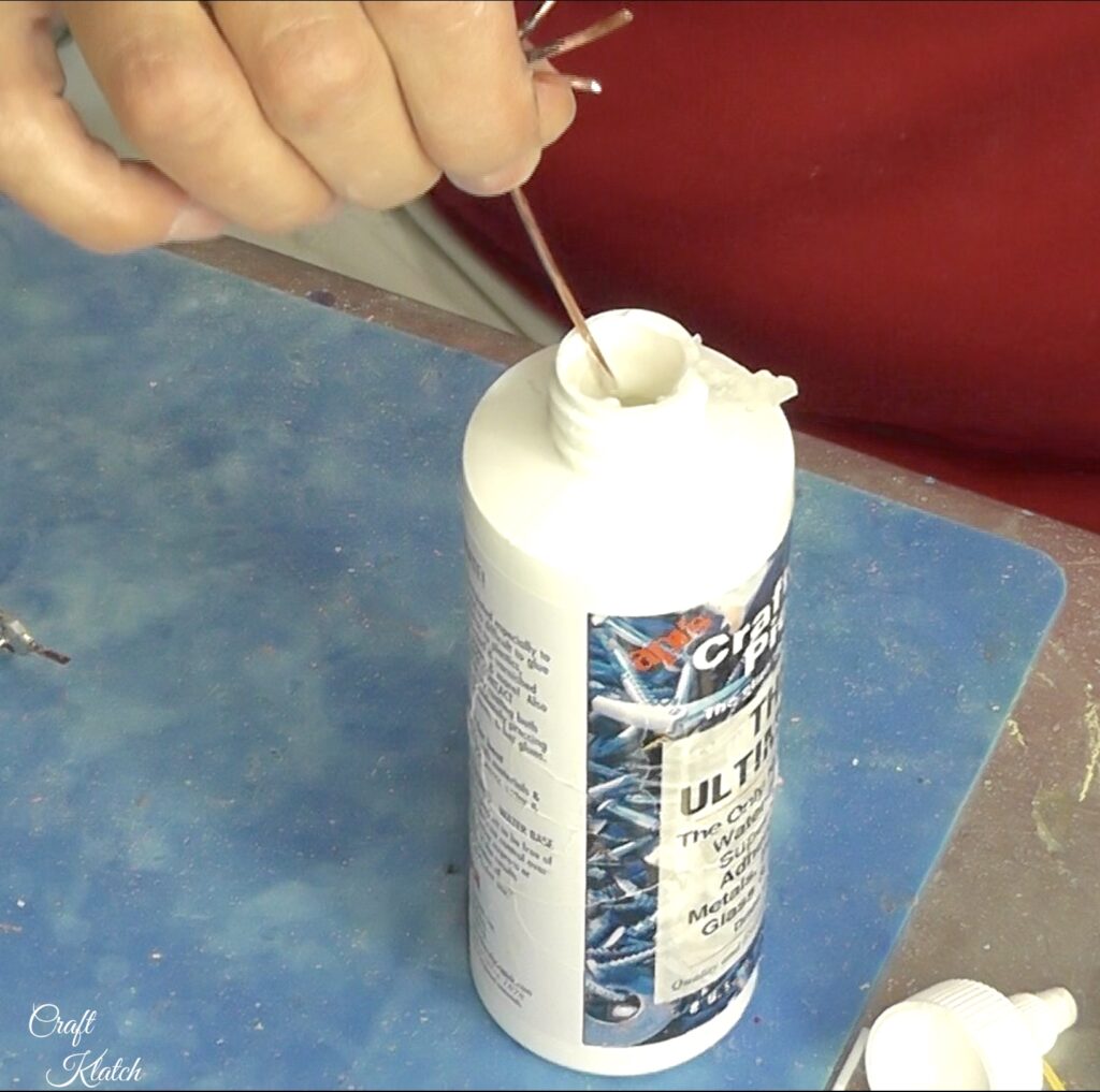Dip tips of bird legs into glue