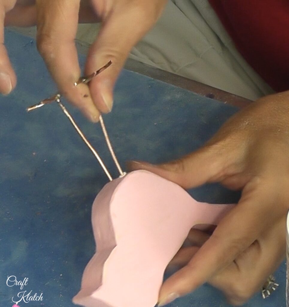 Insert wire legs with glue into the wood bird