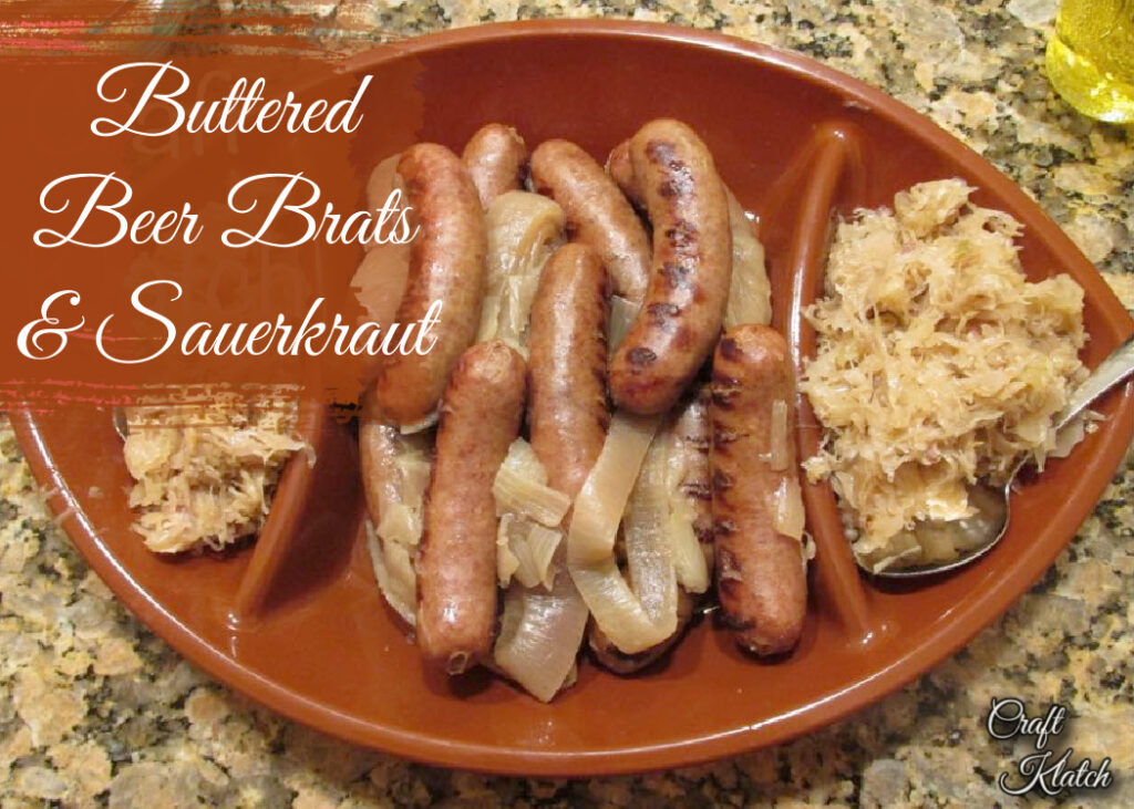 Buttered beer brats and sauerkraut on platter