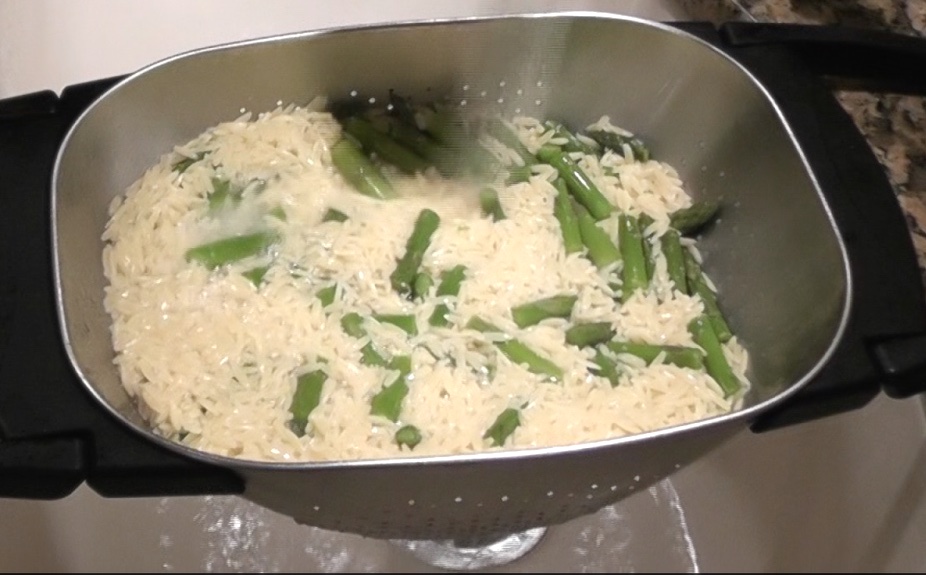 drain orzo and asparagus in a strainer and rinse with cold water