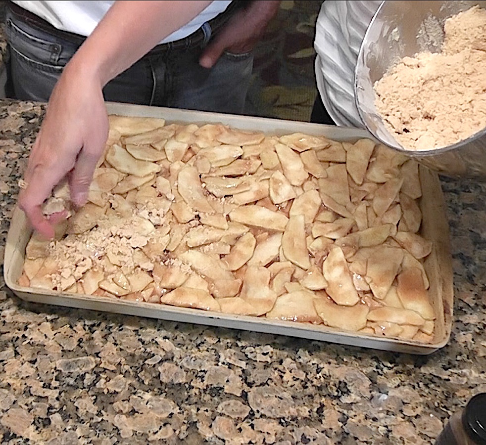 sprinkle streusel crumb topping over apple filling