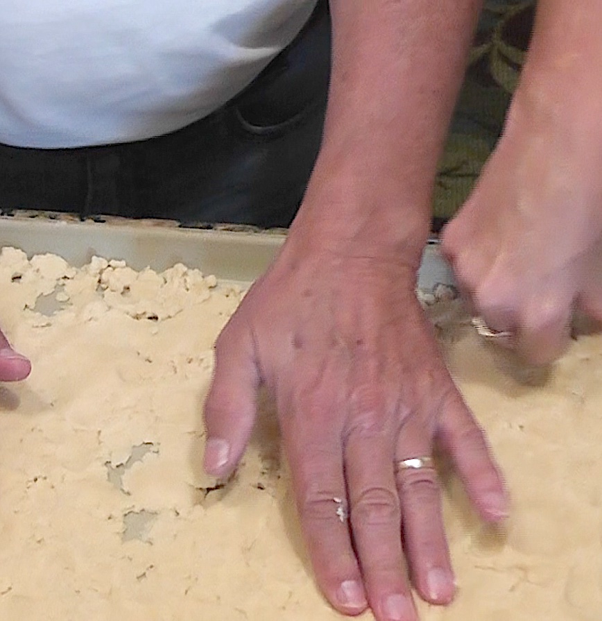 Press dough into stone pan