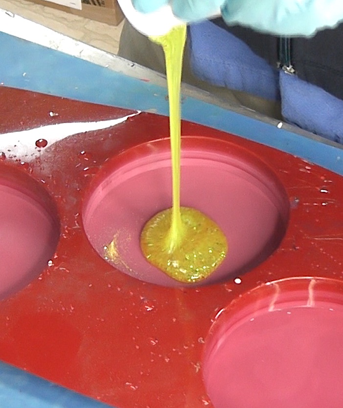 Pour yellow glitter resin into the coaster mold