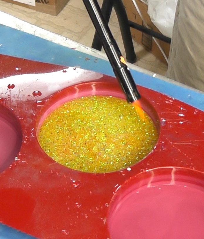 Use a lighter to pop the bubbles in the resin for the skull coaster