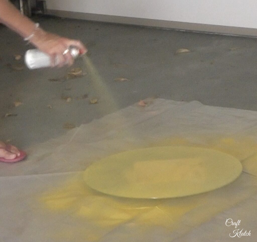 Spray glass top with yellow spray paint