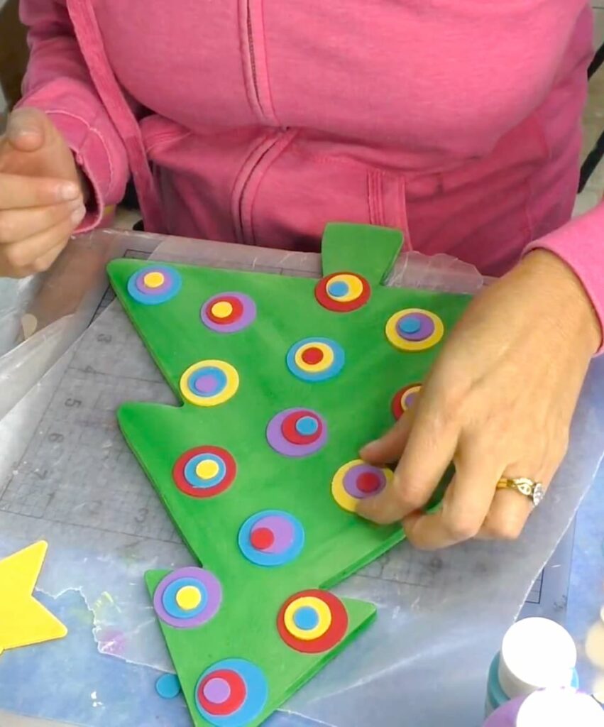 arranging and stacking the circles on the whimsical Christmas tree