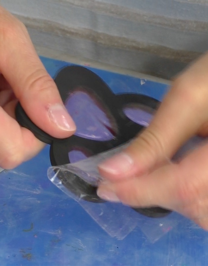 Removing packing tape from the back of the paw coasters