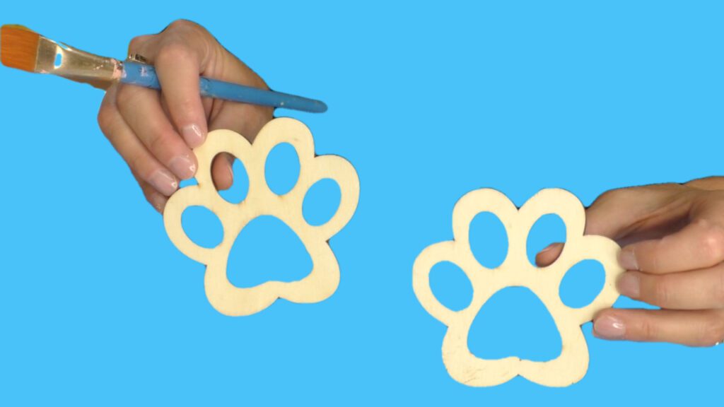 Wood blanks in the shape of pet paws to be crafted into coasters