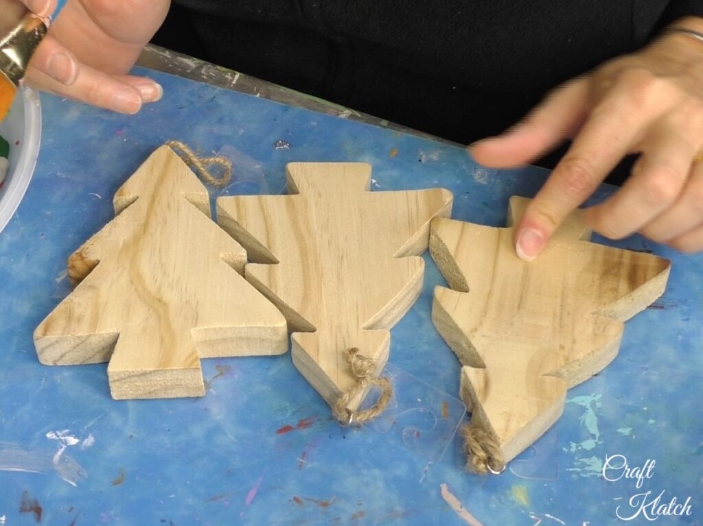 Three unfinished wood Christmas trees