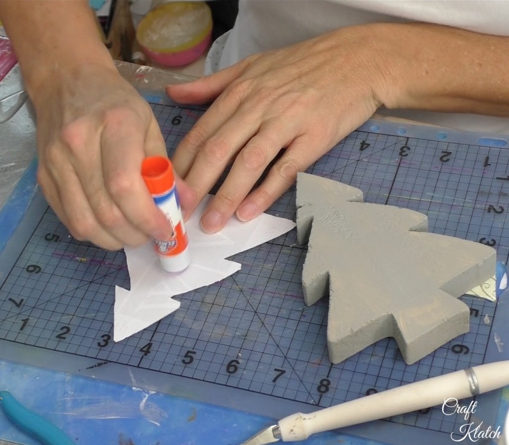 Apply stick glue on the back of the scrapbook paper tree cut out