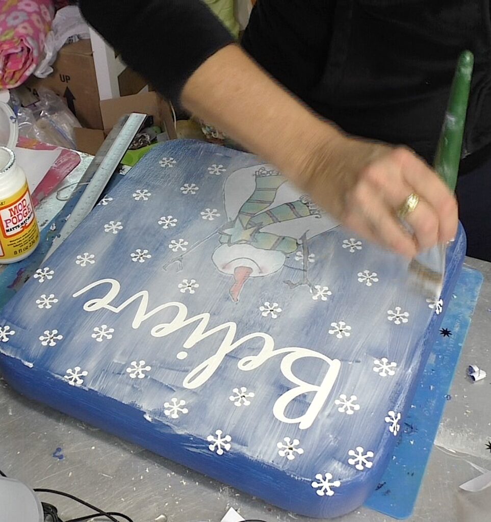 Decoupage over the snowman sign