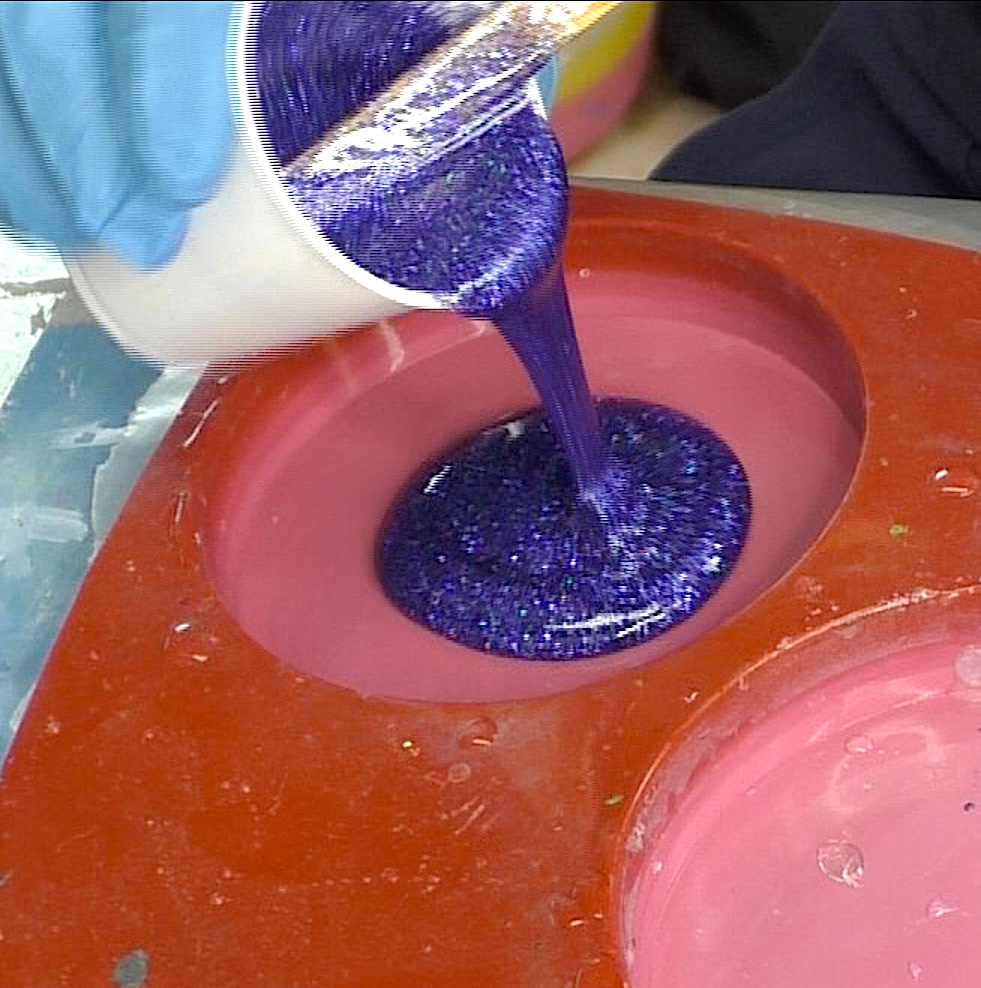 Pour blue resin and glitter mixture into coaster mold