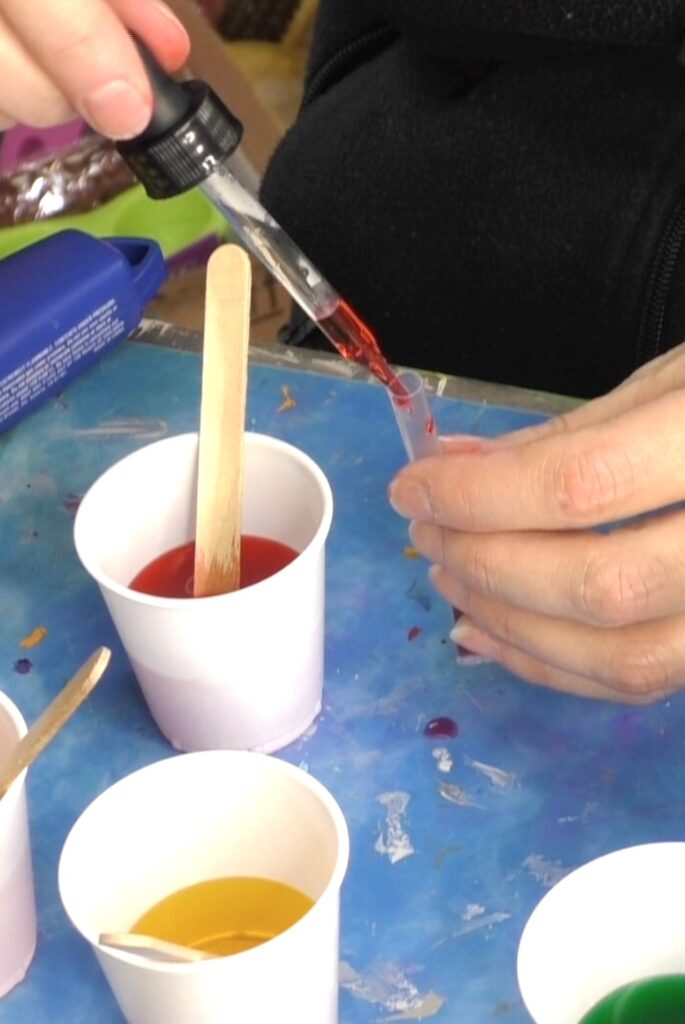 Drip colored water into the straws