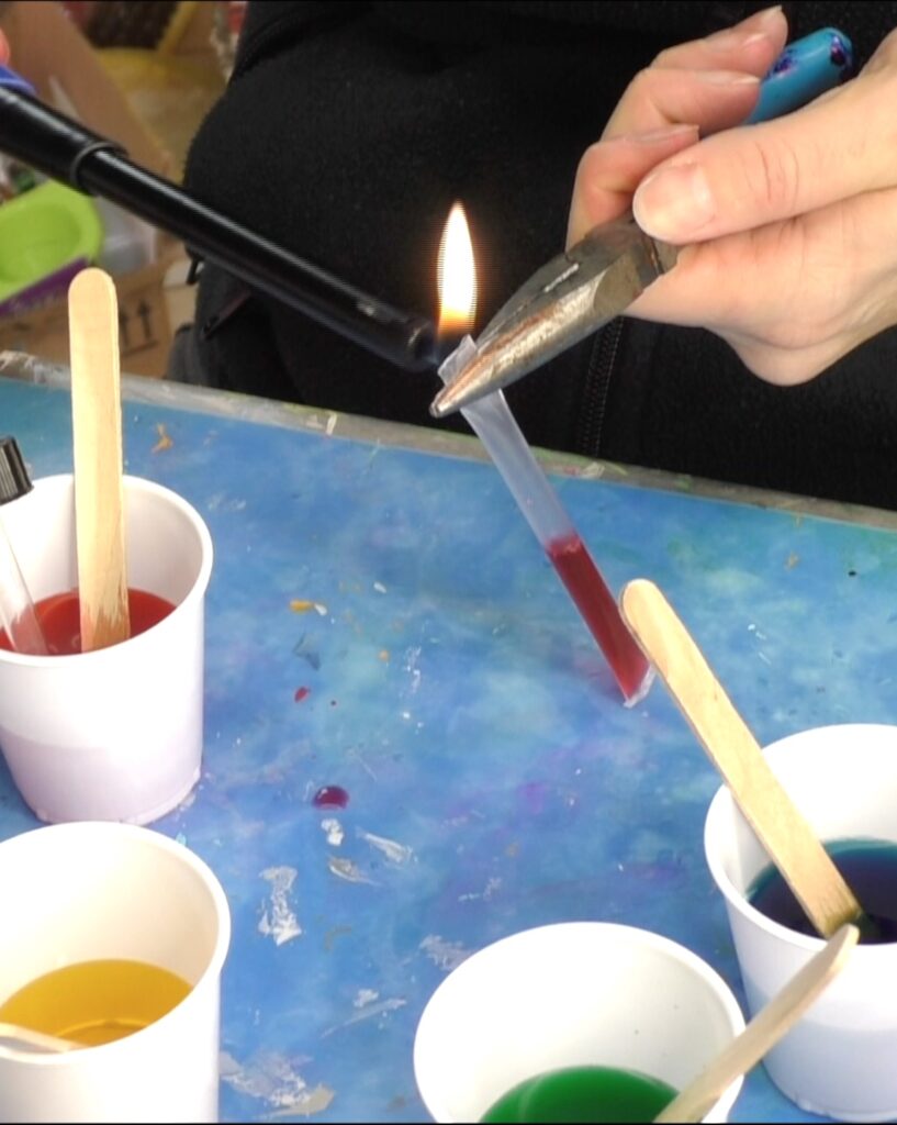 Use pliers to melt the end of the straw closed