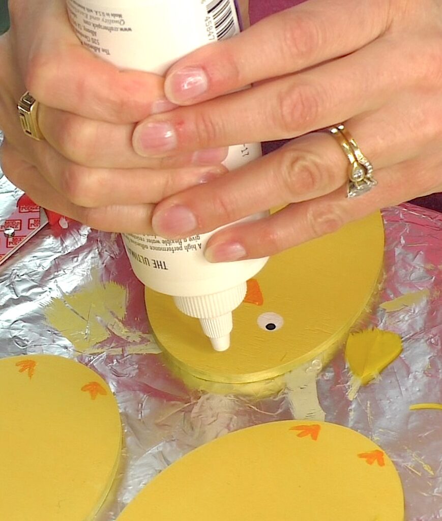Add a dot of glue to the top of the chick head