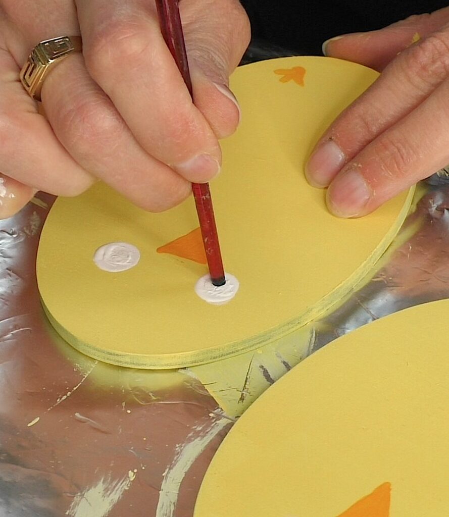 Add black dot for pupils to the white of the eyes for the chick Easter craft