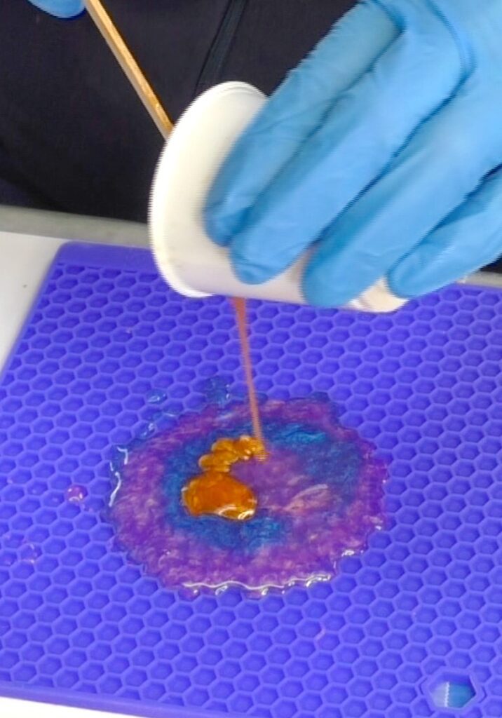 Pouring resin on the silicone mat for the free form resin coasters