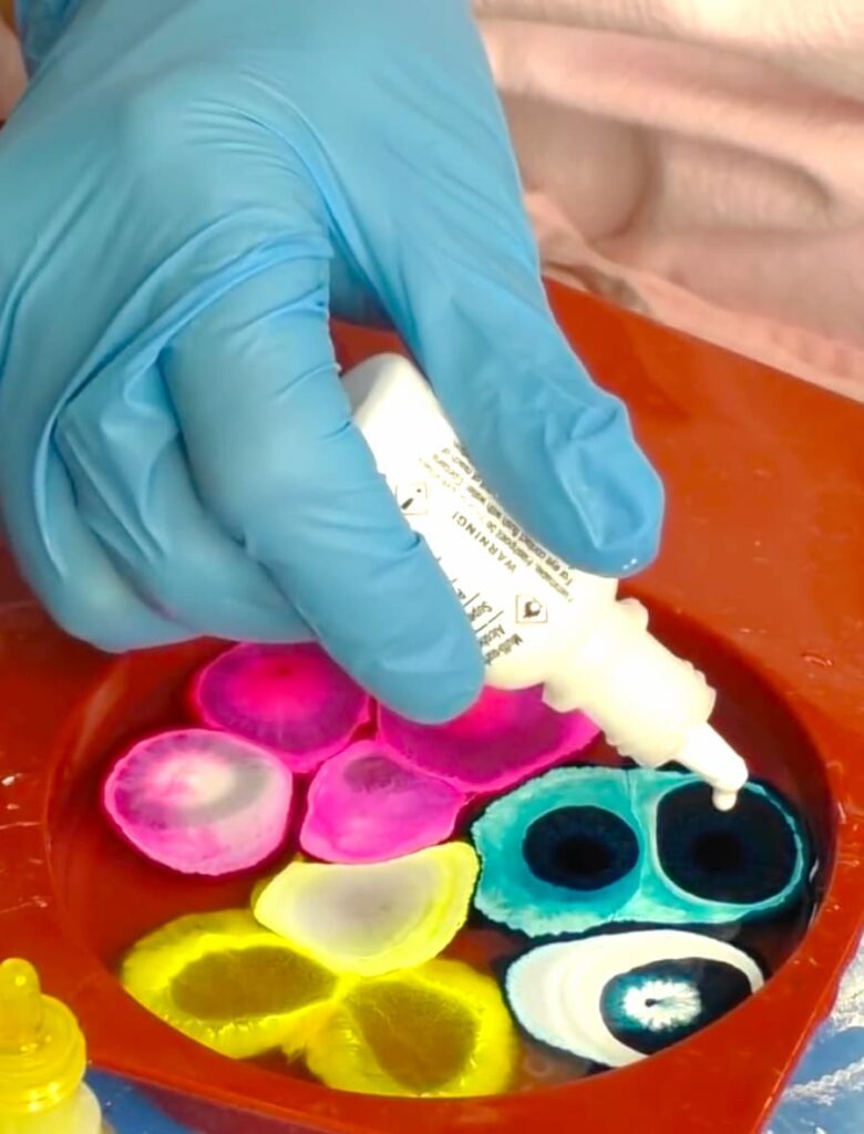 Dripping white alcohol ink into petri dish coaster