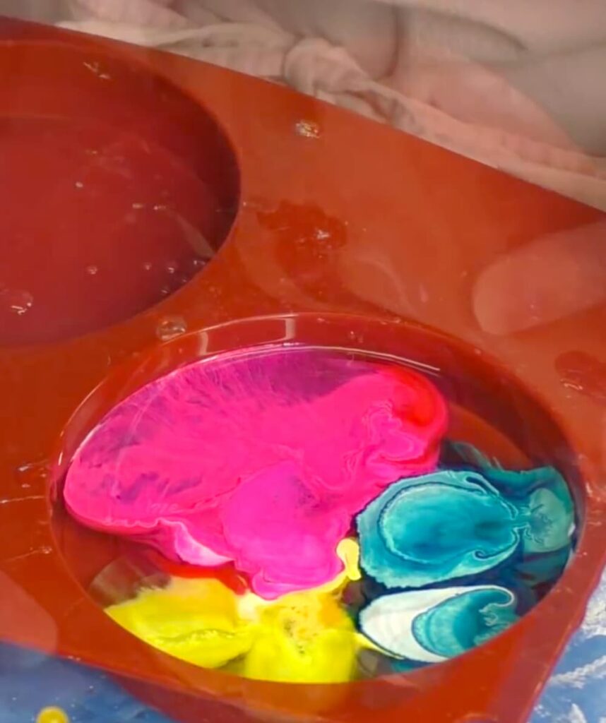 resin and alcohol ink in a resin coaster left to cure