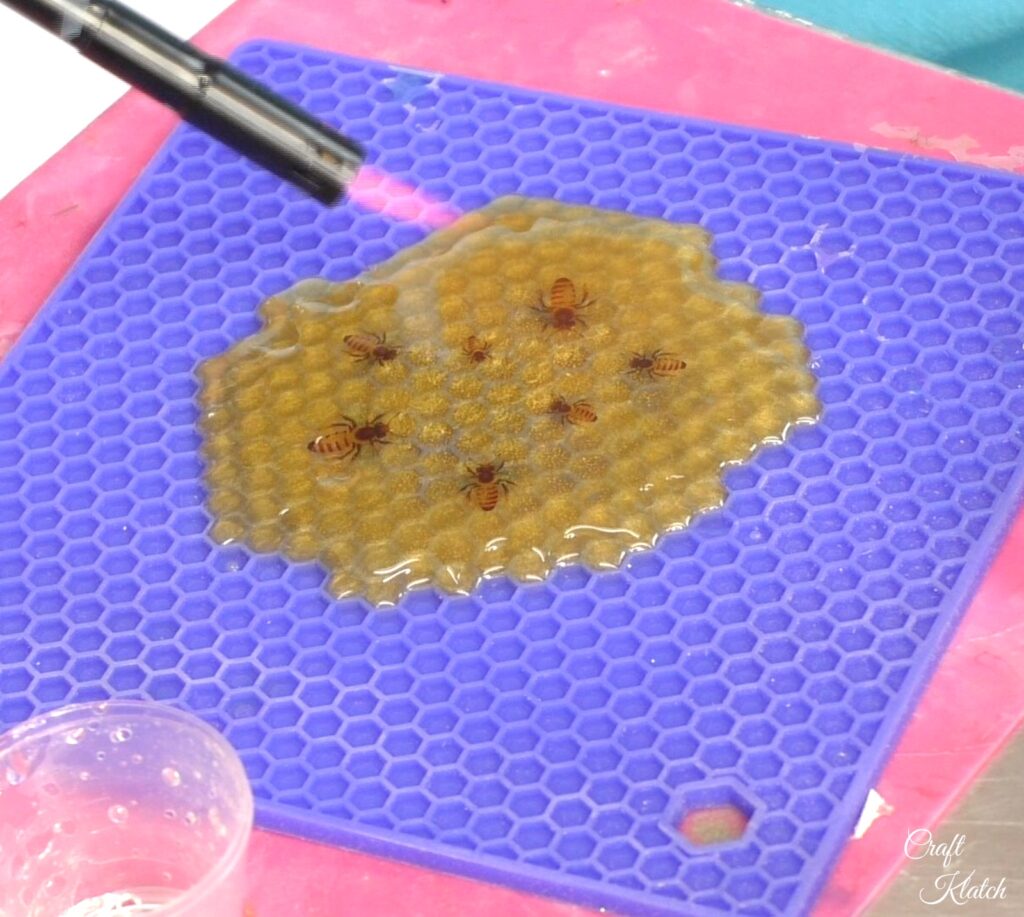 Use lighter to pop bubbles on Honeycomb Bee Coaster