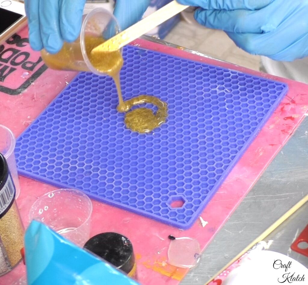 Pour gold resin onto silicone mat for freeform style