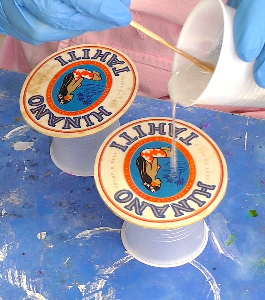 Preserving bar coasters by pouring resin over them