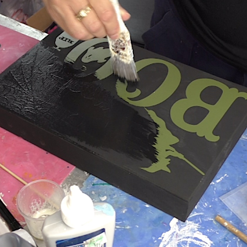 Paint black over the vinyl on the Halloween sign