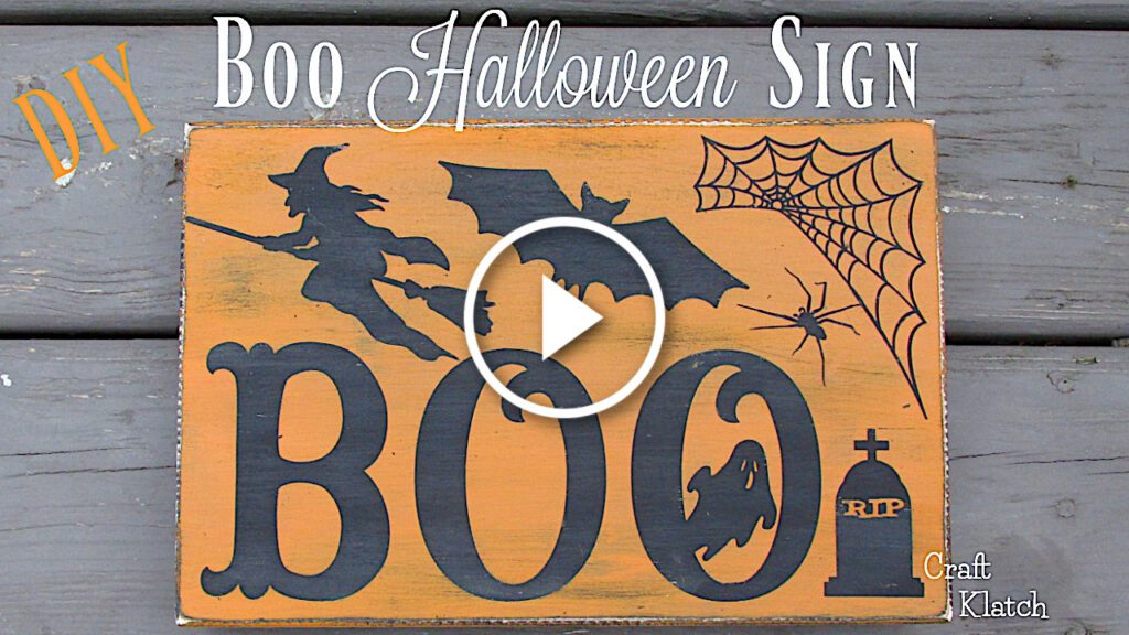 Halloween sign with book, bat, witch and spiderweb