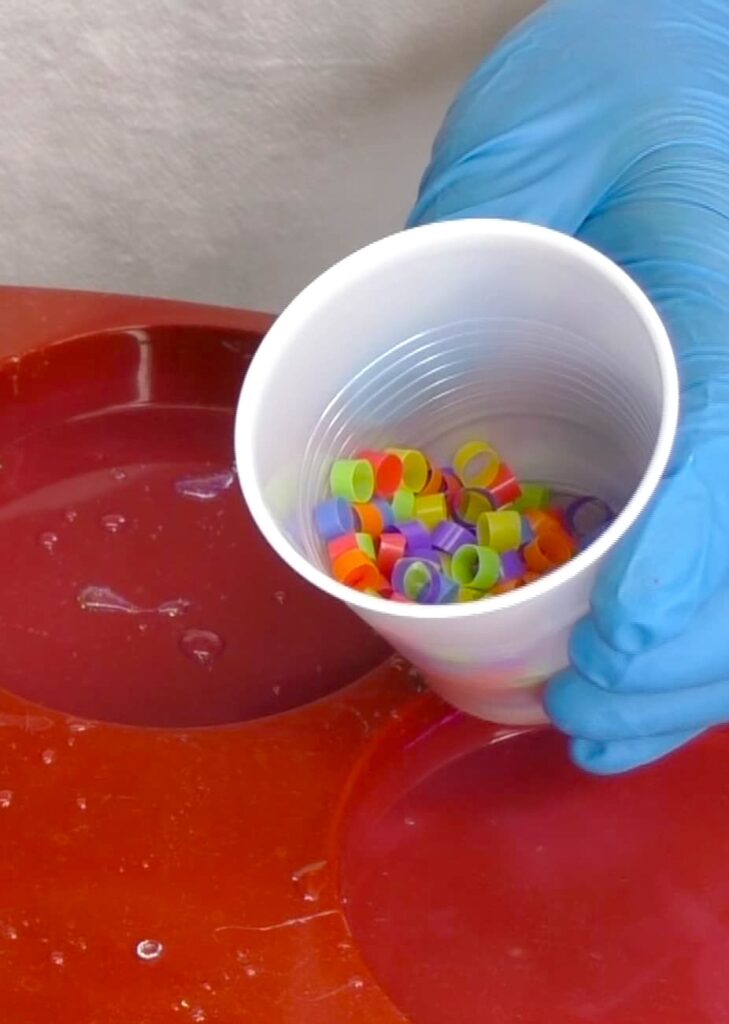 Cut colorful drinking straws into small pieces for a resin coaster craft