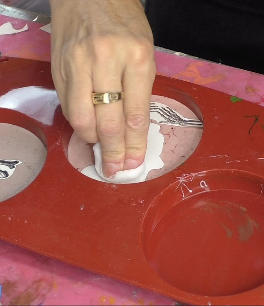 Use damp paper towel to moisten the skull tattoo