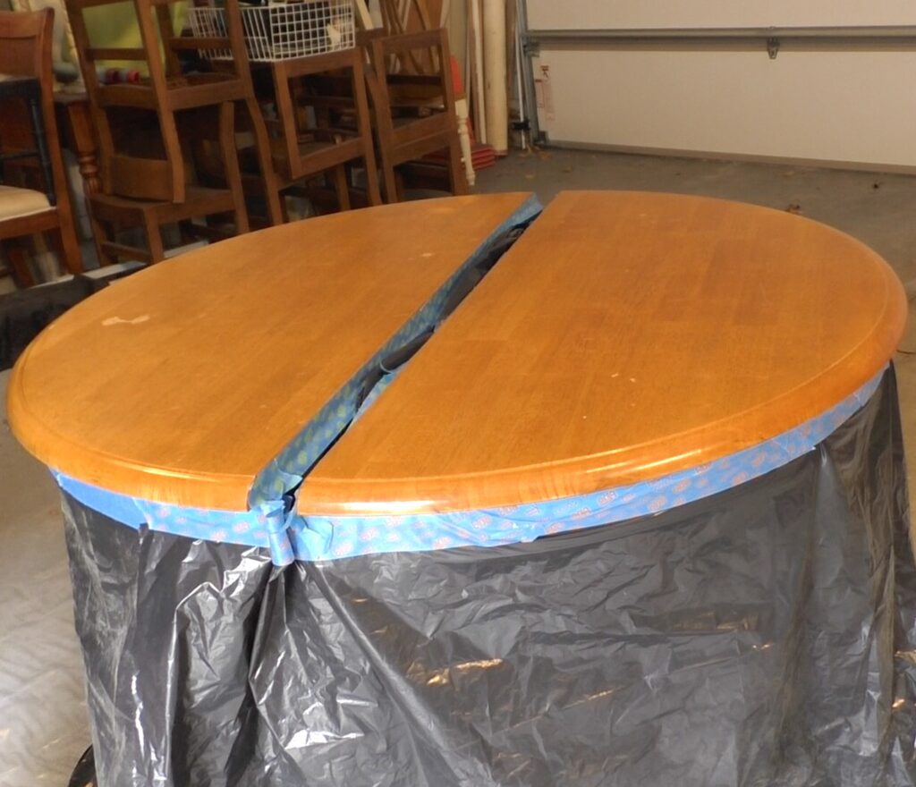 Table is wrapped to protect sides and pedestal during the refinish