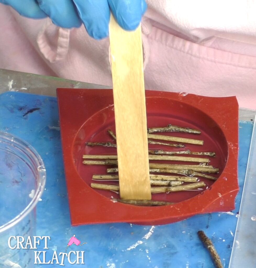 Press the twigs down into the resin