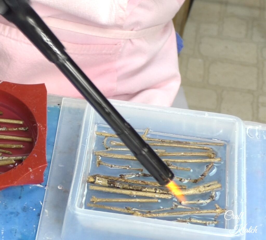 Use a lighter to pop the bubbles of the twig coasters