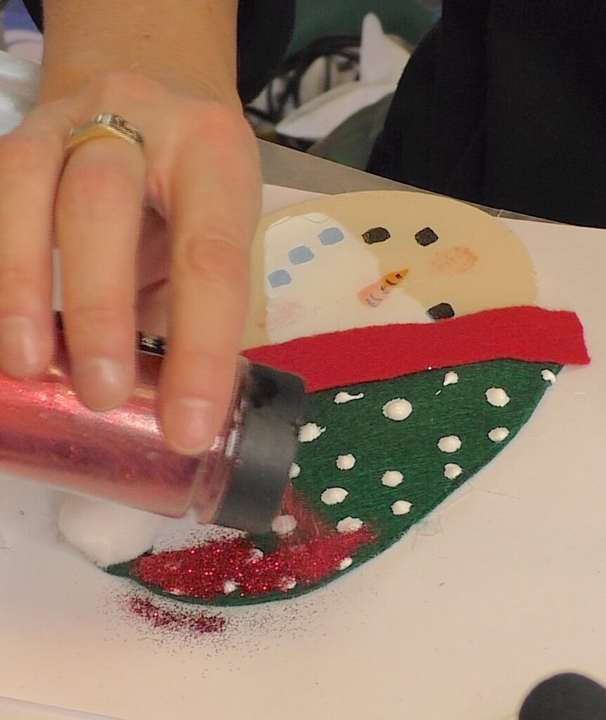 Sprinkle glue dots with fine glitter