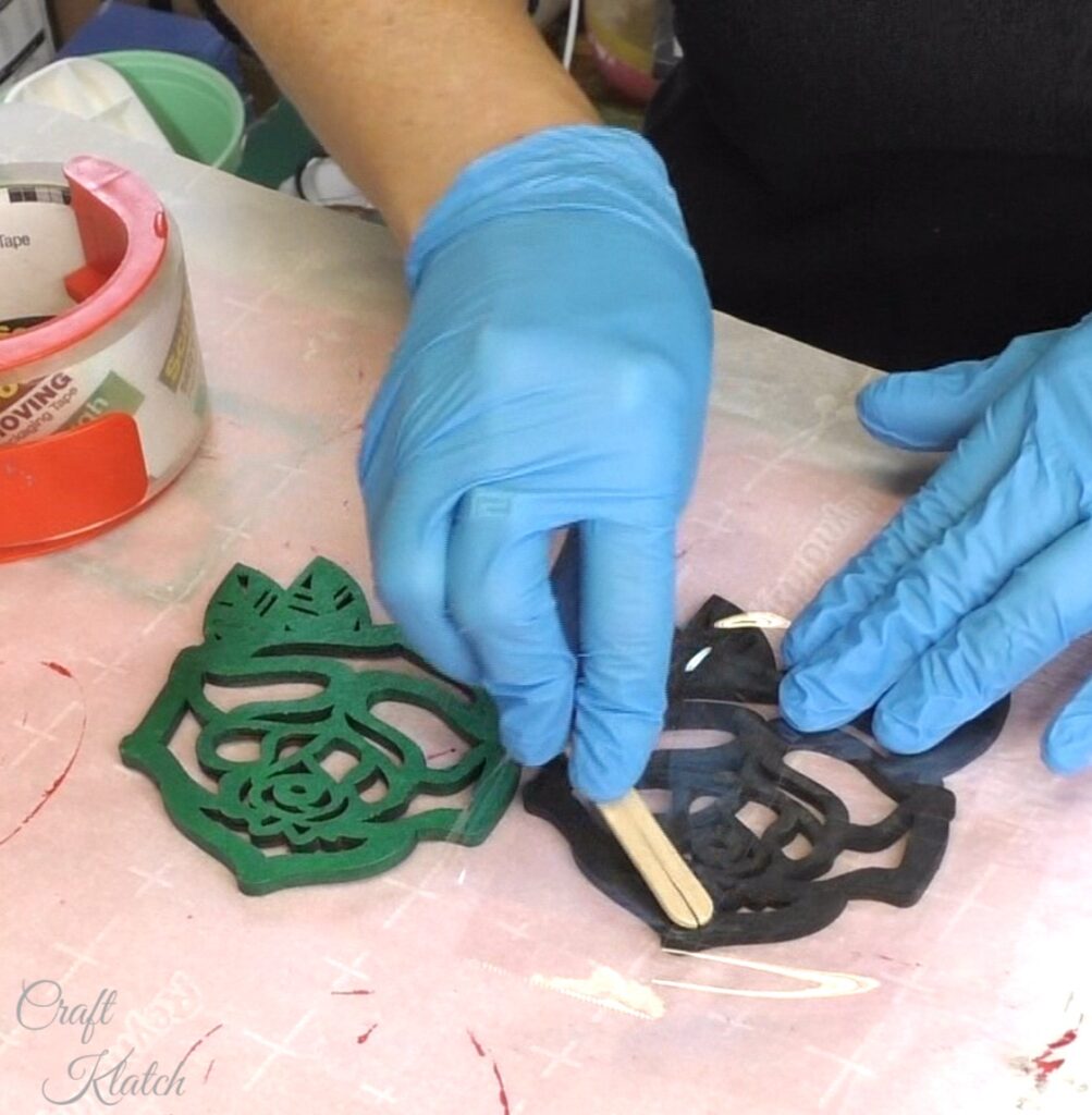 Burnish the tape onto the backs of the wood rose coasters