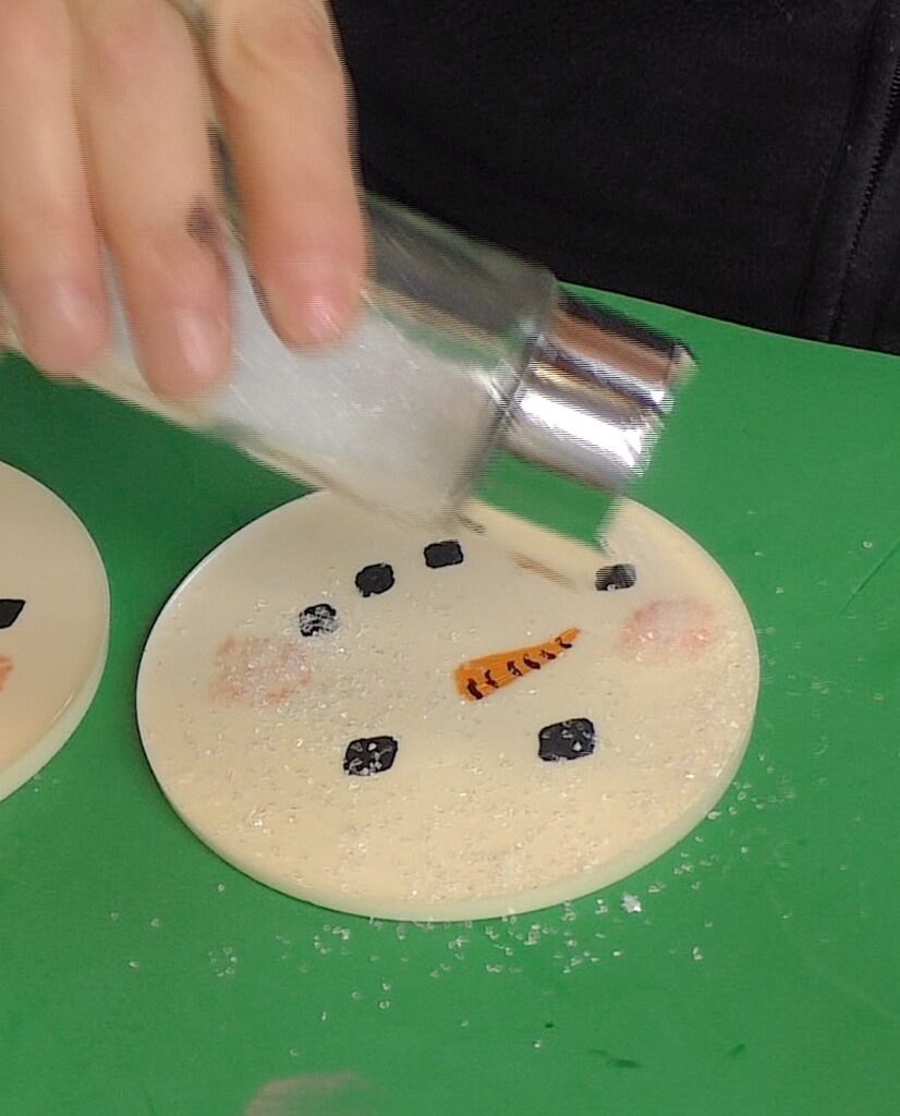 Pour on chunky white glitter to the snowman craft