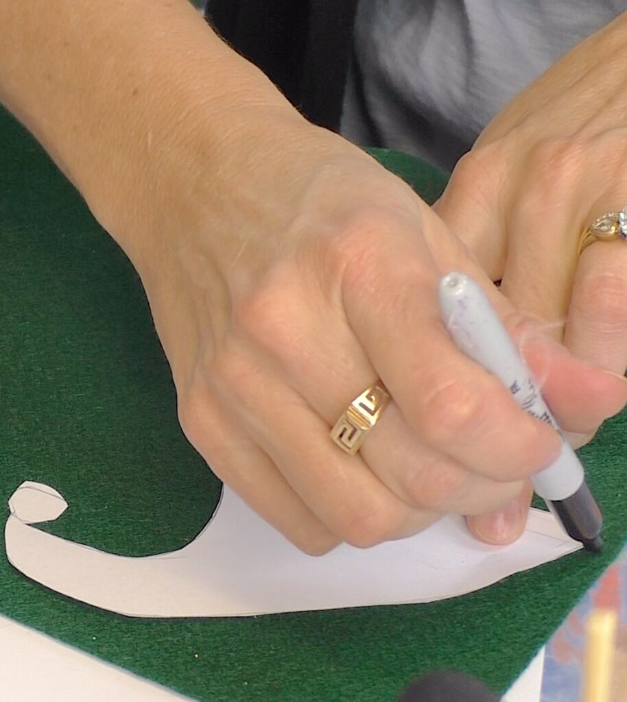 Trace around the cap onto felt for snowman craft