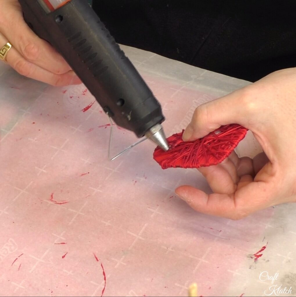 Wrap and glue red string around red heart