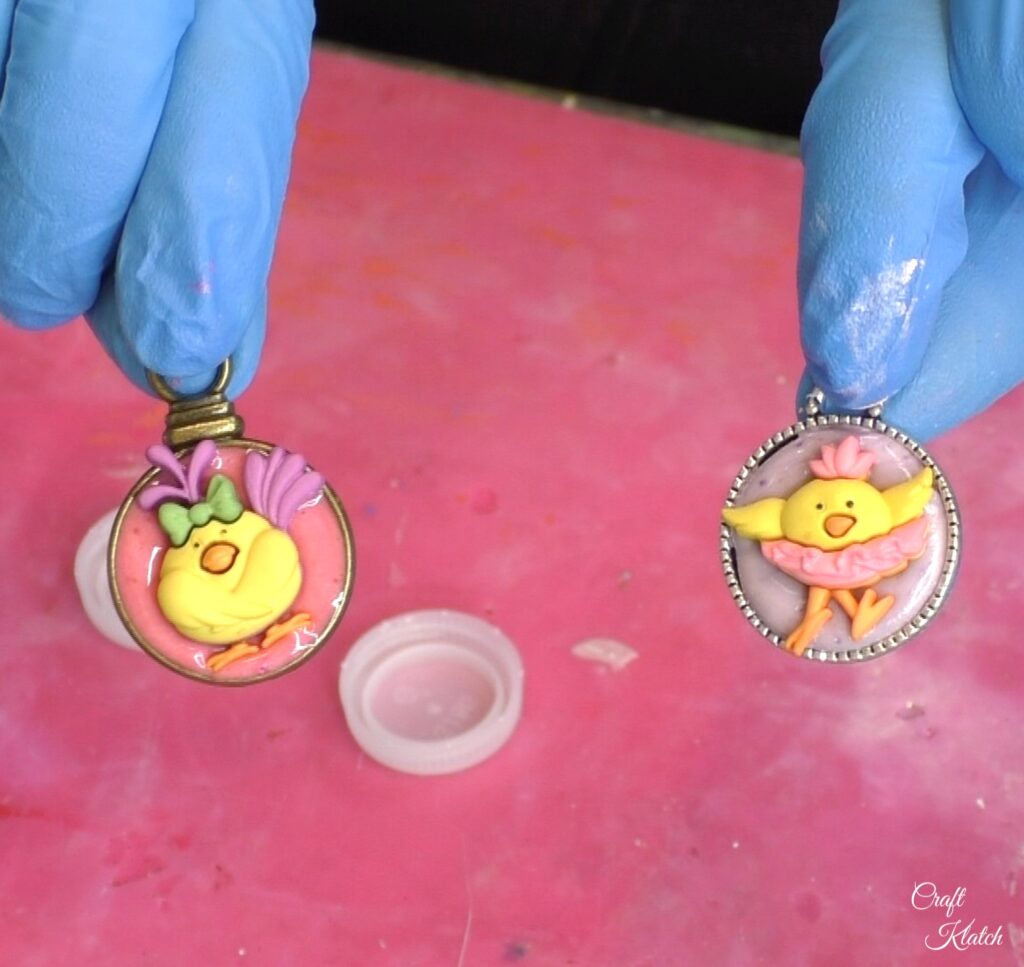 Holding two purple and pink cute chick charms