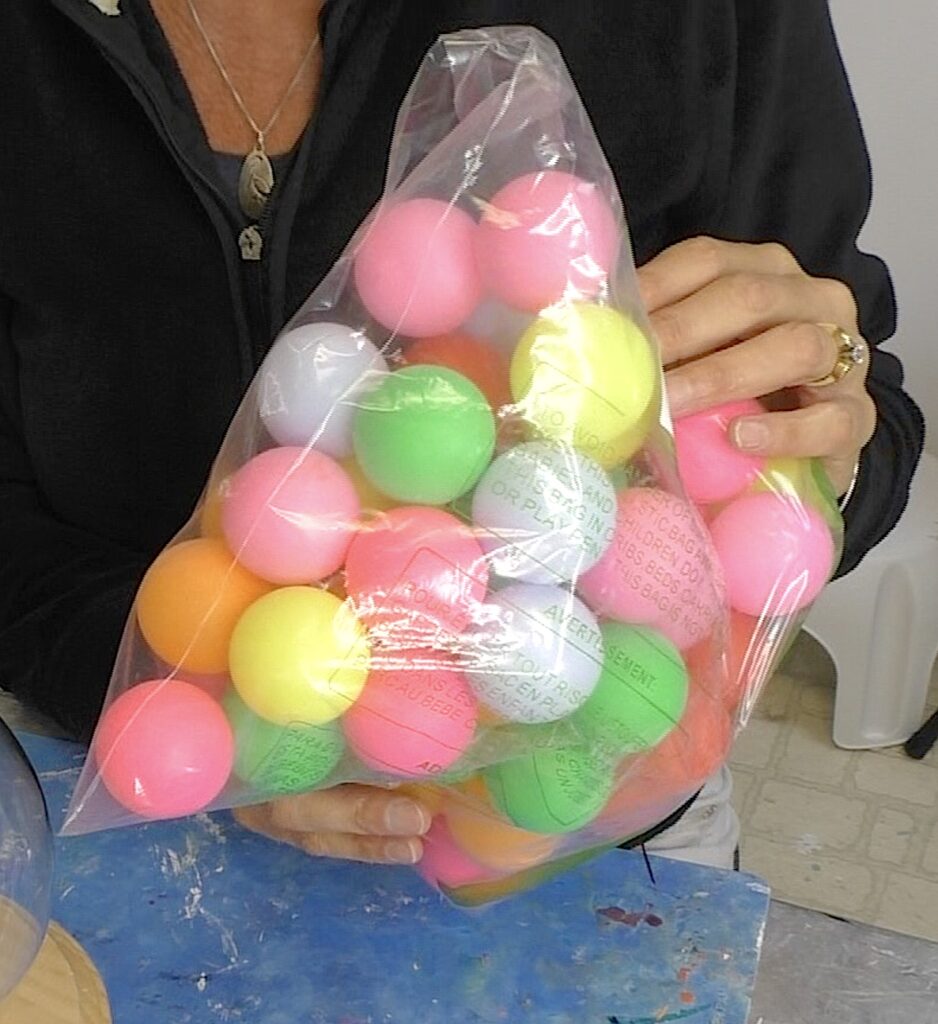 Bag of colorful ping pong balls for gumball lamp diy ideas