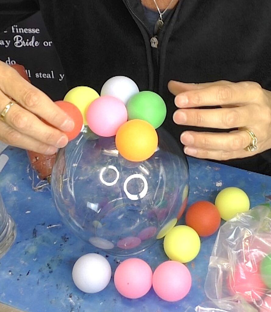 Sticking colorful ping pong balls on gumball lamp