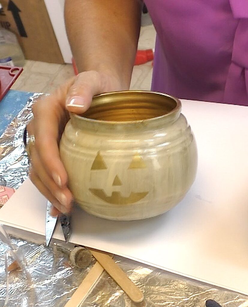 Ivory glass pumpkin jar with gold face