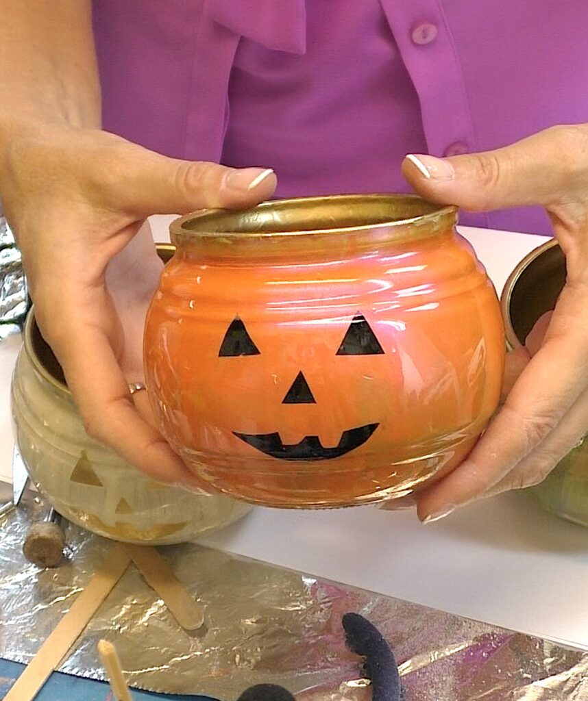 Orange glass pumpkin decoration with black features