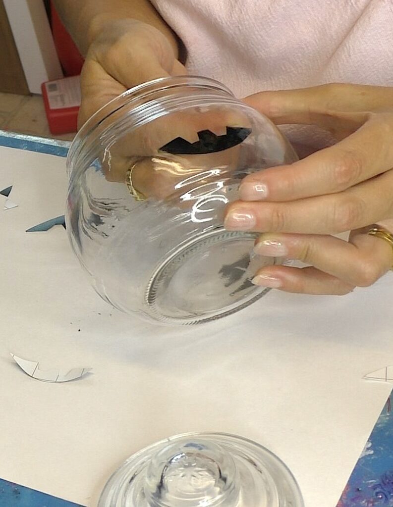 Stick the black vinyl pieces to the inside of the glass pumpkins