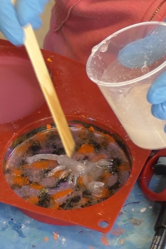 Place scorpion in the glow in the dark resin coaster