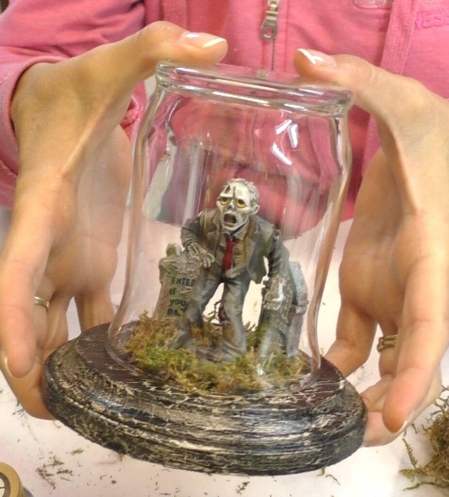 Put glass upside down over the zombie. It's like a cemetery decor terrarium which makes diy easy halloween decorations