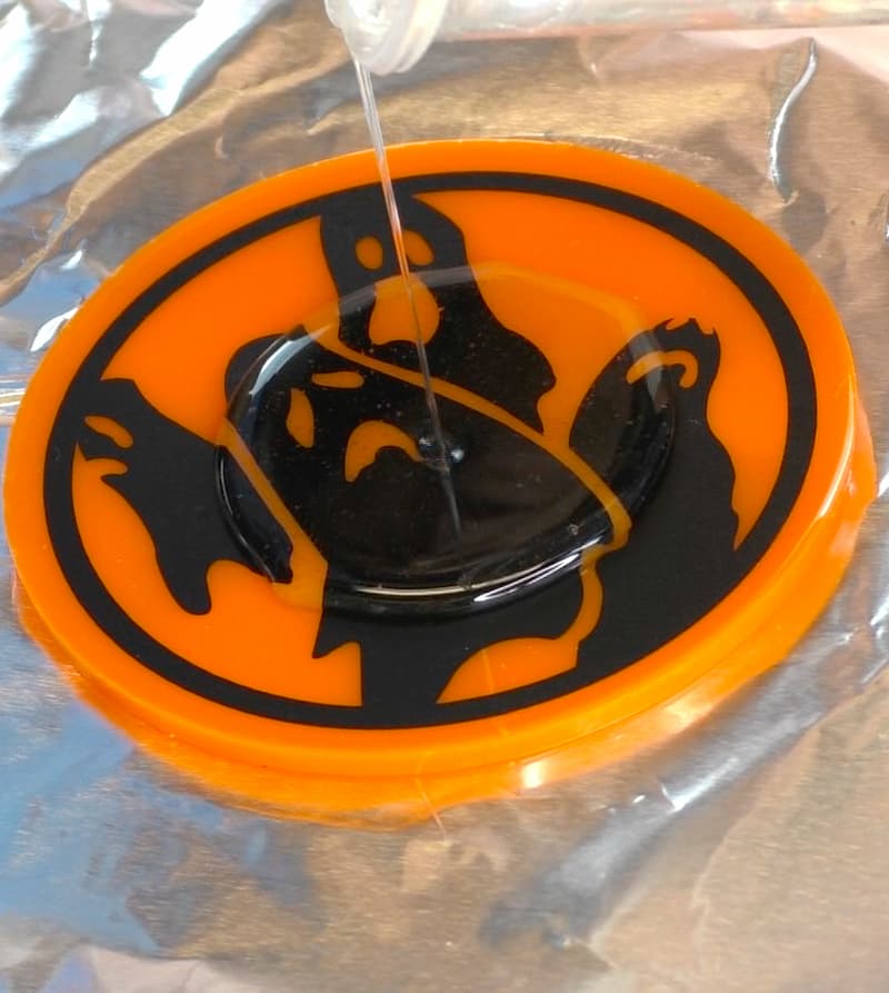 Pouring resin onto the ghost coaster Halloween craft