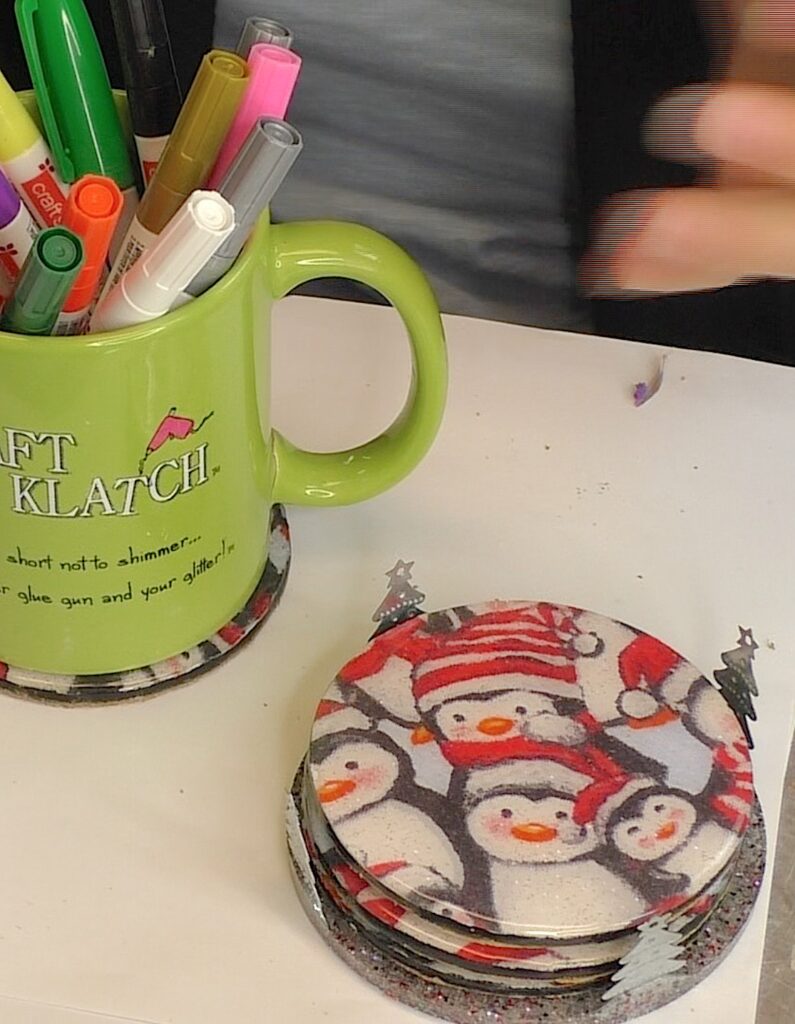 completed Christmas penguin craft with resin coasters and a holder