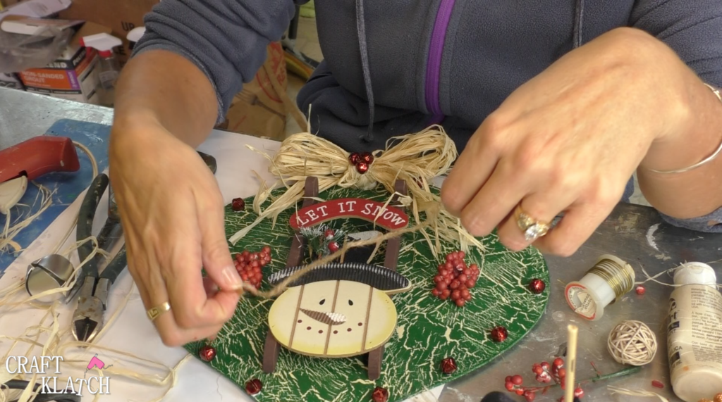 I found this ornament at Dollar Tree, in fact I found four! I decided I would style the ornament four different ways! This is the first and I'm going for a Rustic Snowman Christmas Ornament DIY! Dollar store crafts are a great way to decorate on a budget and customize your Christmas decorations to reflect your personal style and home decor ideas! #craftklatch #holidaydecorations #dollartree #dollartreecrafts #christmas #christmascraft #christmascraftideas #diy #craft #crafts #crafting #craftideas #howto #christmasdecor, Adding string back to the ornament