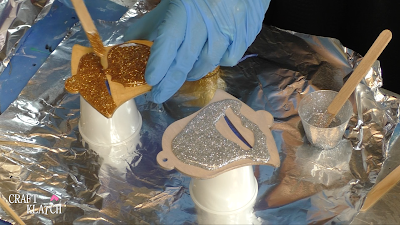 Learn how to make Christmas Bell Resin coasters! It's great home decor idea for decorating for the holidays and because the wood cutouts are from Dollar Tree, they are great for decorating on a budget! #craftklatch #craftideas #christmas #christmascraftideas #christmascrafts #diy #howto #crafts #crafting #glittercrafts #resin #resincrafts #resindiys #resinart #resincoasters #dollartree #dollartreecrafts #decoratingonabudget